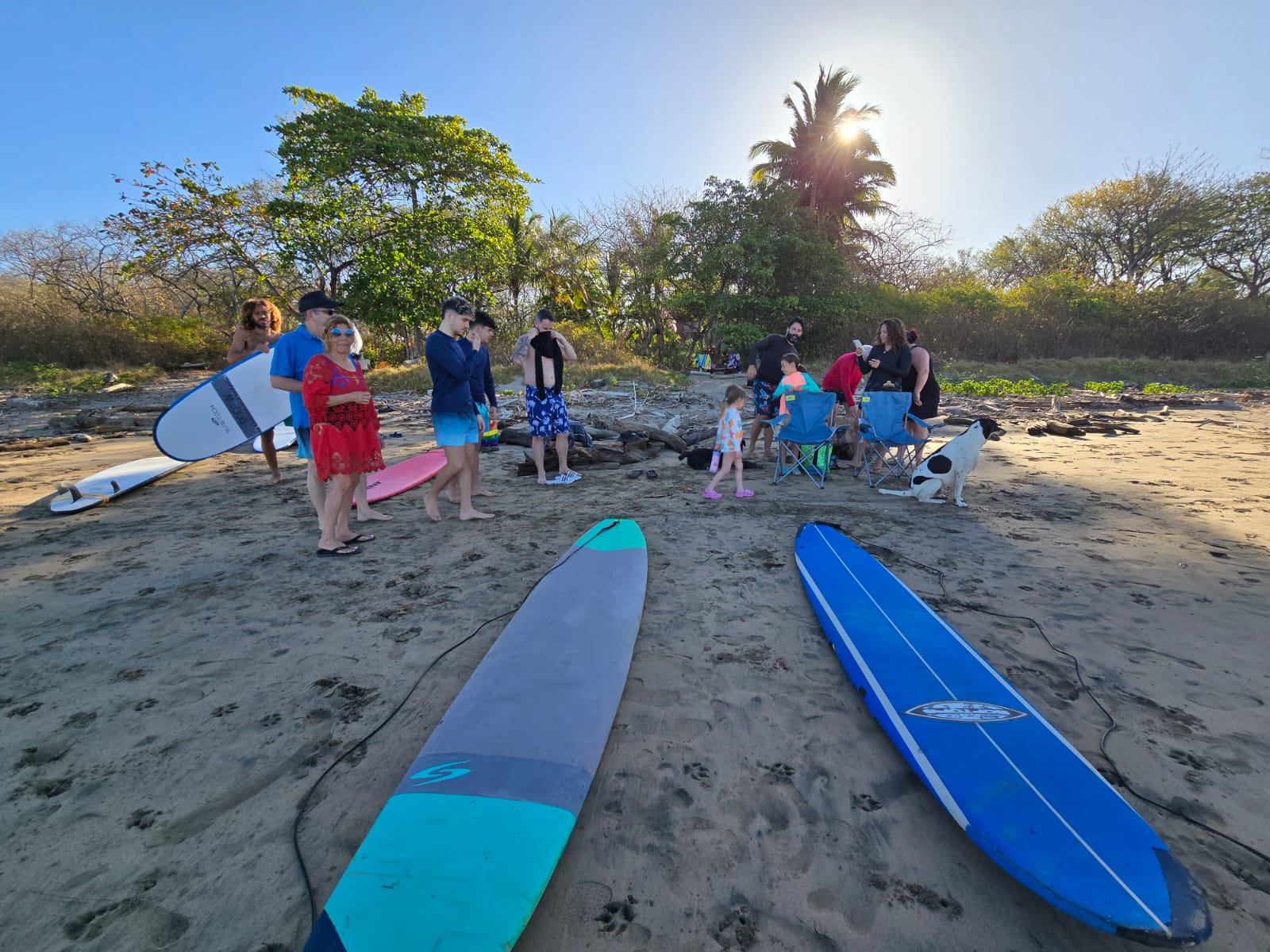 Group surf lesson gathering on the beach at golden hour